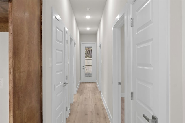 corridor with light wood-type flooring