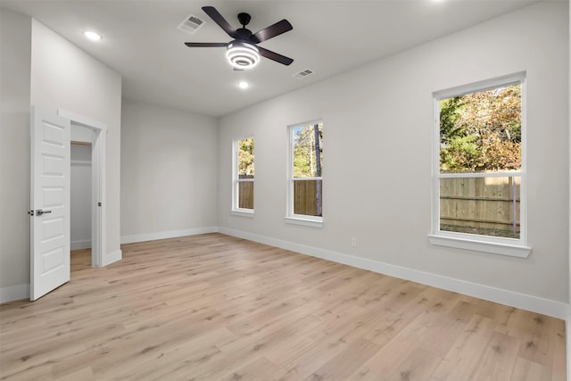 unfurnished bedroom with light hardwood / wood-style flooring, multiple windows, and ceiling fan