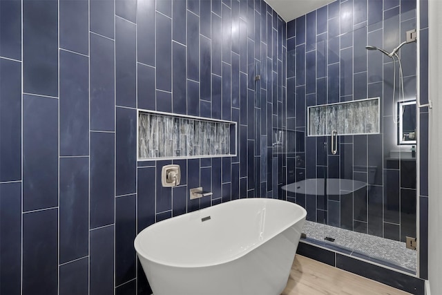 bathroom with independent shower and bath and tile walls