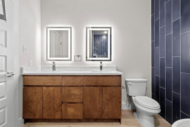 bathroom featuring vanity, toilet, and wood-type flooring