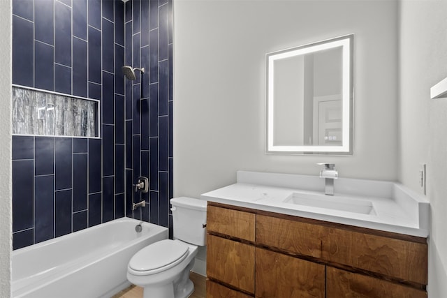 full bathroom with vanity, tiled shower / bath combo, and toilet