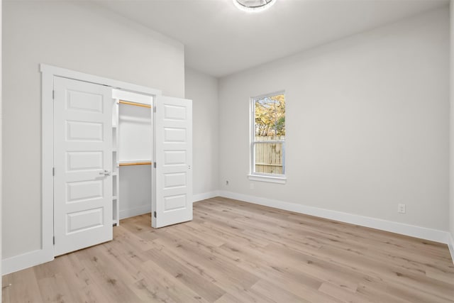 unfurnished bedroom featuring light hardwood / wood-style floors and a closet