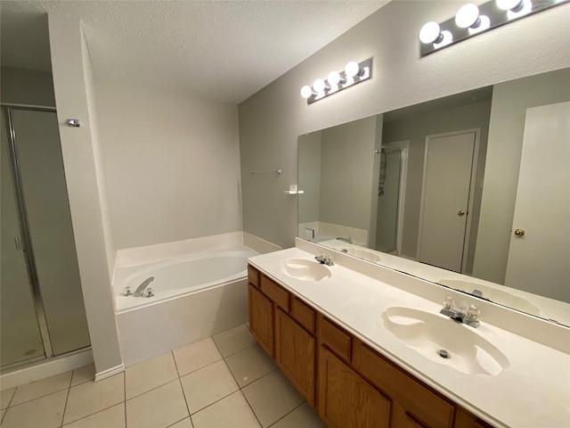 bathroom featuring tile patterned flooring, vanity, independent shower and bath, and a textured ceiling