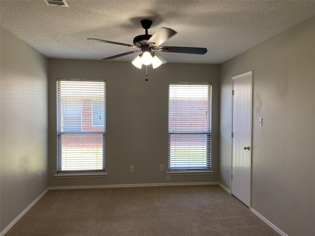 spare room featuring ceiling fan, a textured ceiling, and carpet flooring