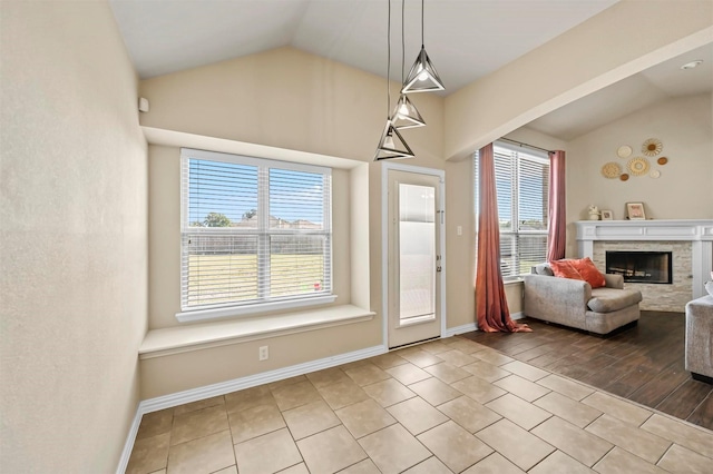 entryway featuring a wealth of natural light, light hardwood / wood-style flooring, and lofted ceiling