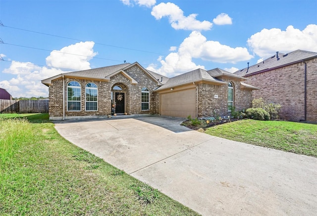 ranch-style house featuring a garage and a front lawn