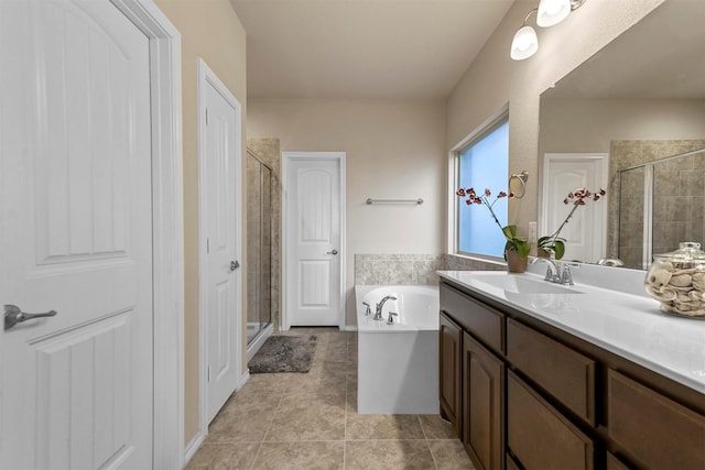 bathroom featuring tile patterned floors, vanity, and separate shower and tub