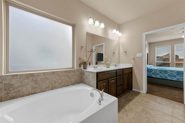 bathroom featuring vanity, ceiling fan, and a bathing tub