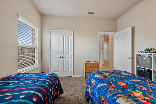 bedroom with carpet floors and a closet