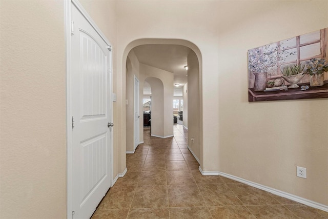 hall with tile patterned flooring