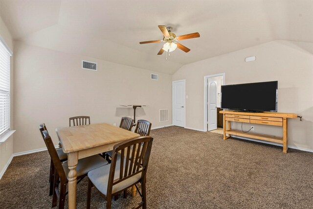 carpeted dining area featuring vaulted ceiling and ceiling fan