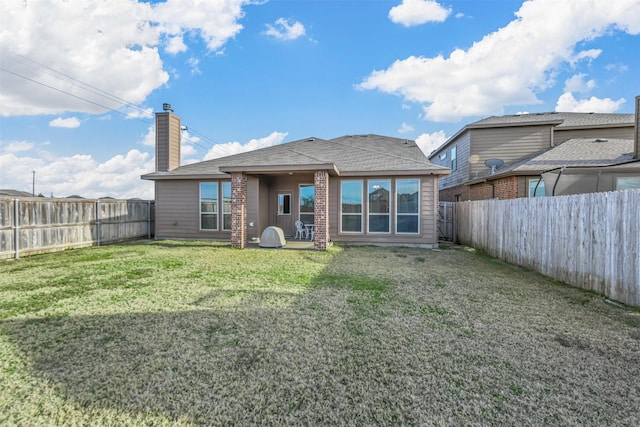 rear view of house featuring a lawn