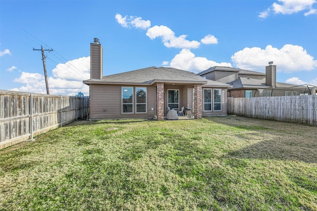 rear view of property featuring a yard