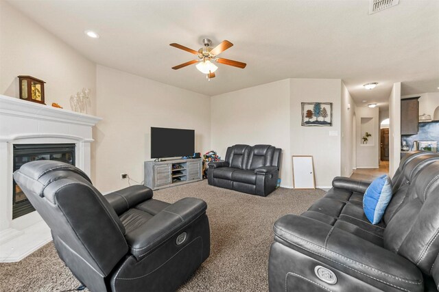 living room with carpet and ceiling fan