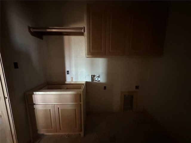 clothes washing area featuring cabinet space and electric dryer hookup