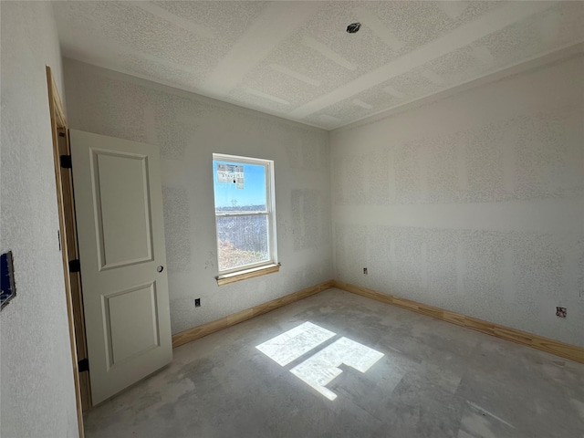 unfurnished bedroom with baseboards and a textured ceiling