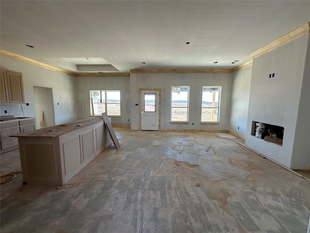 kitchen featuring open floor plan, light brown cabinetry, a fireplace, and a kitchen breakfast bar