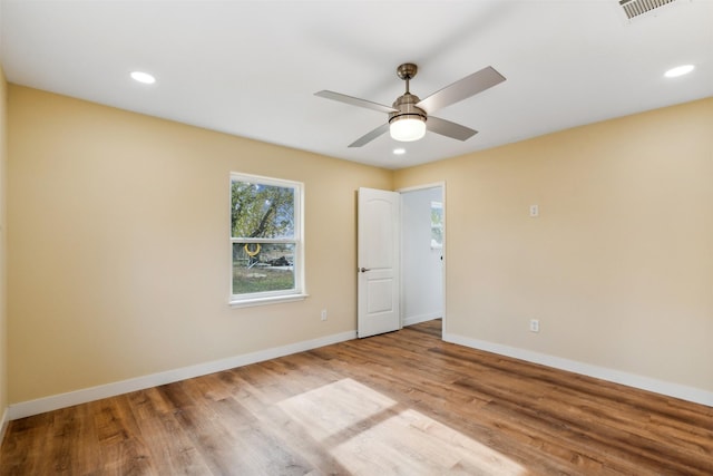 spare room featuring ceiling fan and light wood-type flooring