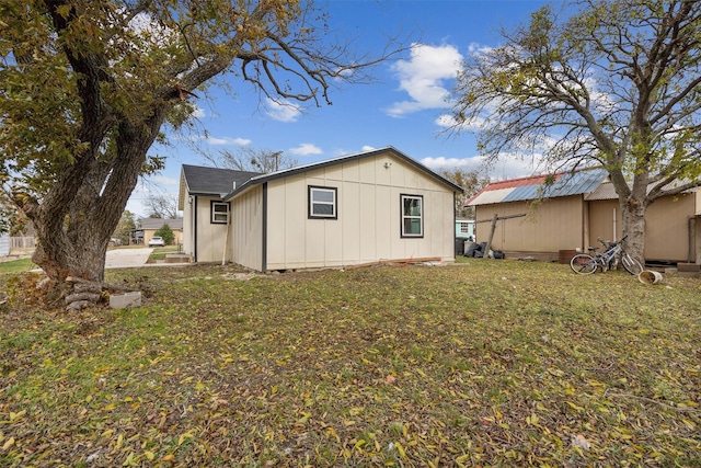 rear view of property with a lawn