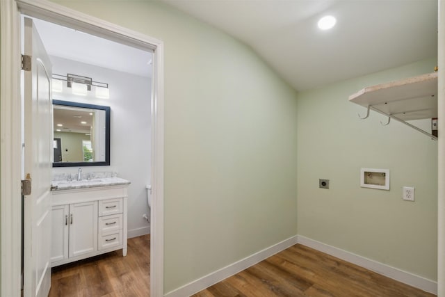 washroom with hookup for an electric dryer, washer hookup, dark wood-type flooring, and sink