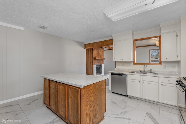 kitchen with sink, range with gas cooktop, a center island, stainless steel dishwasher, and white cabinets