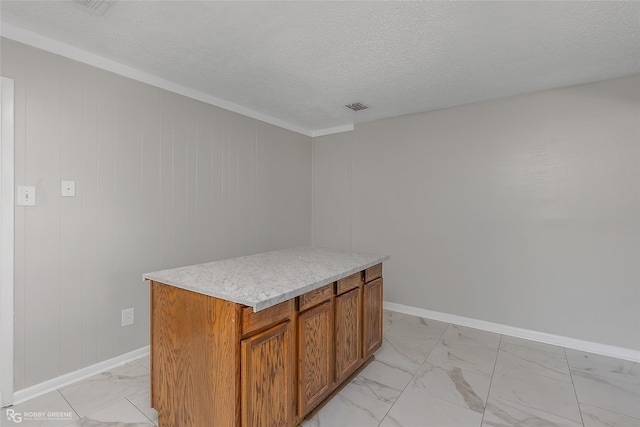 kitchen with a kitchen island and a textured ceiling