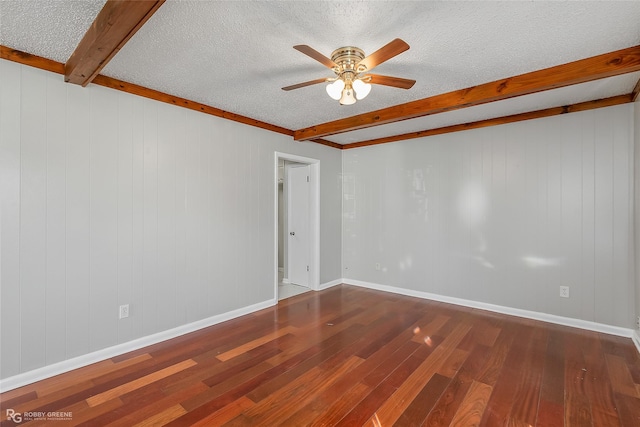 empty room with ceiling fan, beam ceiling, wood-type flooring, and a textured ceiling