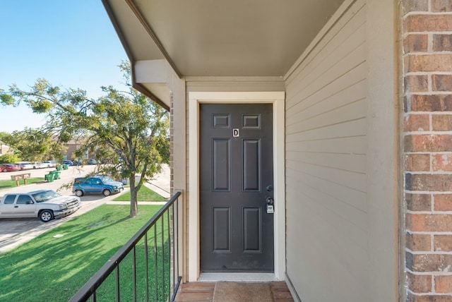 entrance to property with a yard