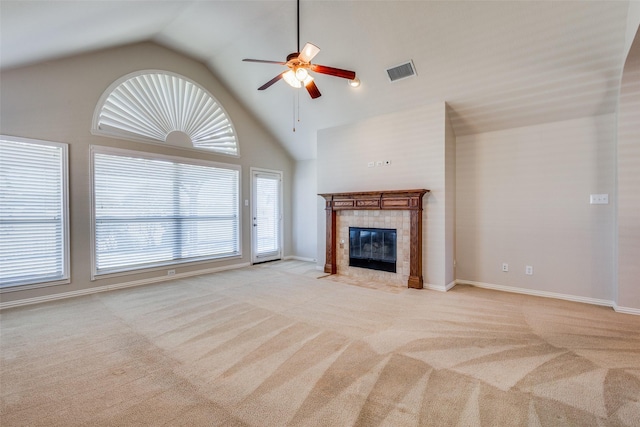 unfurnished living room with light carpet, high vaulted ceiling, a fireplace, and ceiling fan