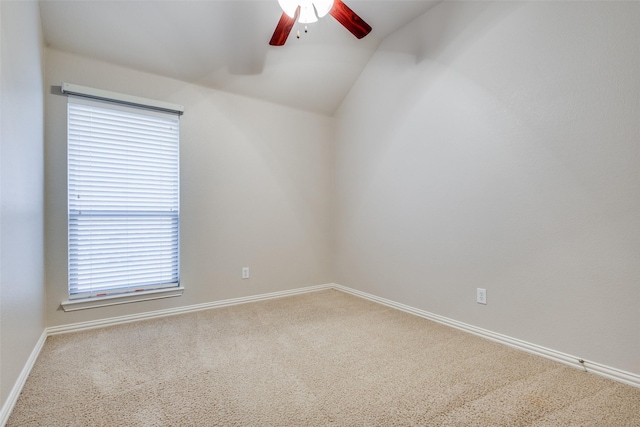 spare room with carpet flooring, plenty of natural light, and lofted ceiling