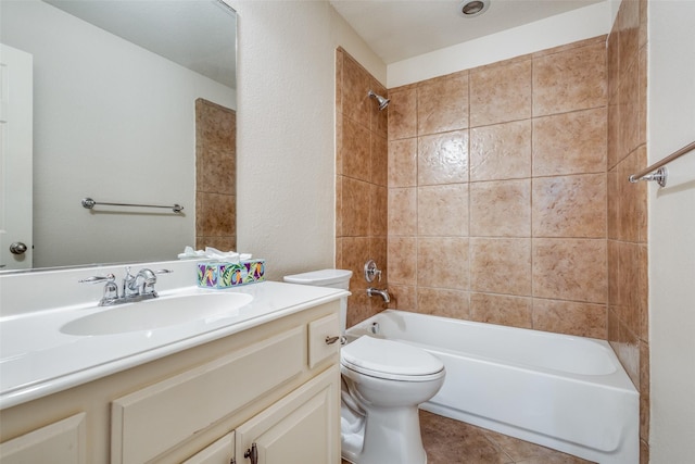 full bathroom with tile patterned flooring, vanity, toilet, and tiled shower / bath