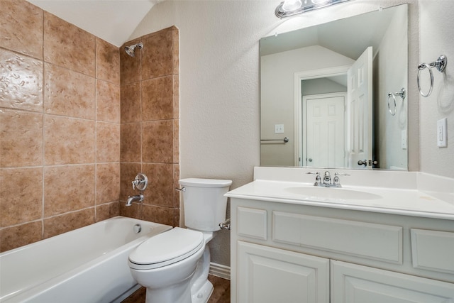 full bathroom featuring tiled shower / bath combo, toilet, lofted ceiling, and vanity