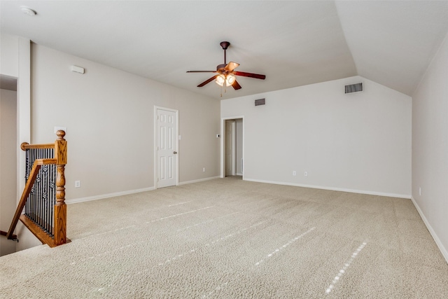 carpeted empty room featuring ceiling fan and lofted ceiling