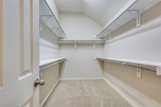 spacious closet with carpet and lofted ceiling