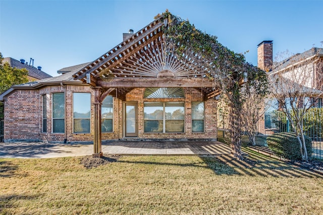 rear view of property with a patio area and a yard