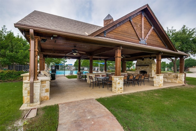 view of property's community featuring a patio area and a lawn