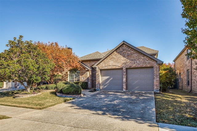 view of front of property with a garage and a front yard