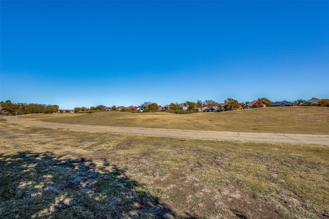 view of yard with a rural view