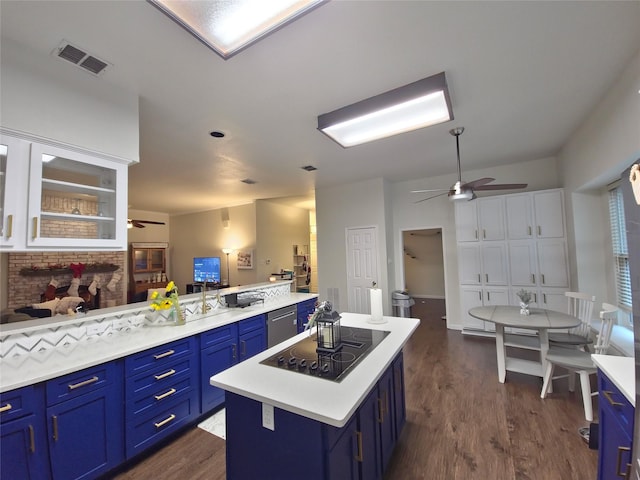 kitchen featuring blue cabinets, dark hardwood / wood-style flooring, a center island, black electric stovetop, and stainless steel dishwasher