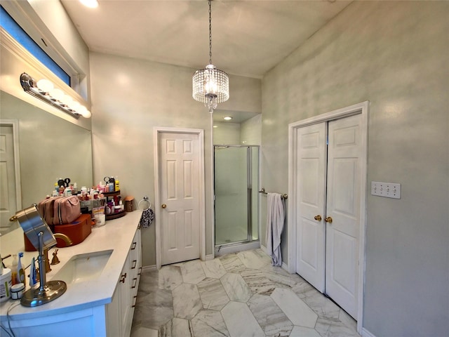 bathroom featuring walk in shower, vanity, and an inviting chandelier