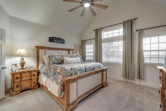 bedroom featuring light carpet, high vaulted ceiling, and ceiling fan