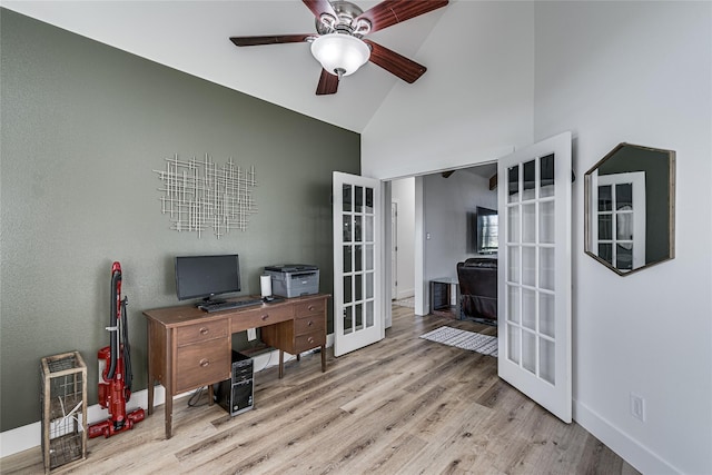 office space with light wood-type flooring, baseboards, a ceiling fan, and french doors