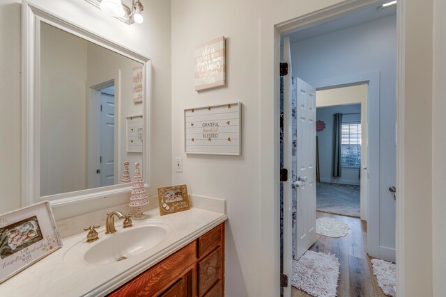 bathroom featuring a chandelier, vanity, and hardwood / wood-style flooring