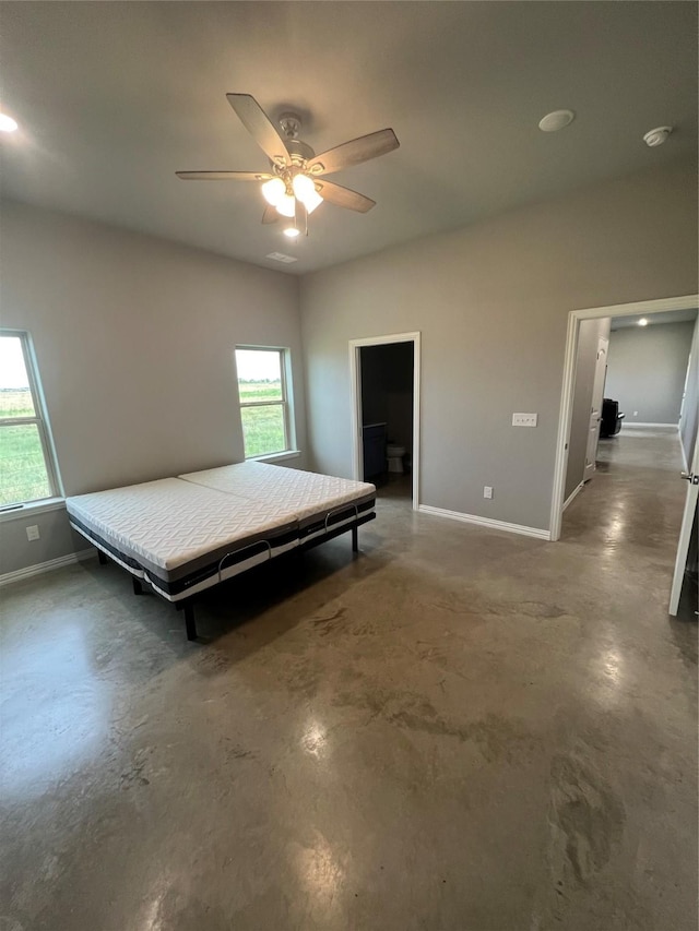 unfurnished bedroom featuring multiple windows and ceiling fan