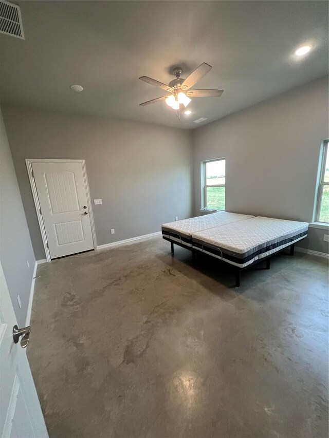 unfurnished bedroom featuring ceiling fan and concrete flooring