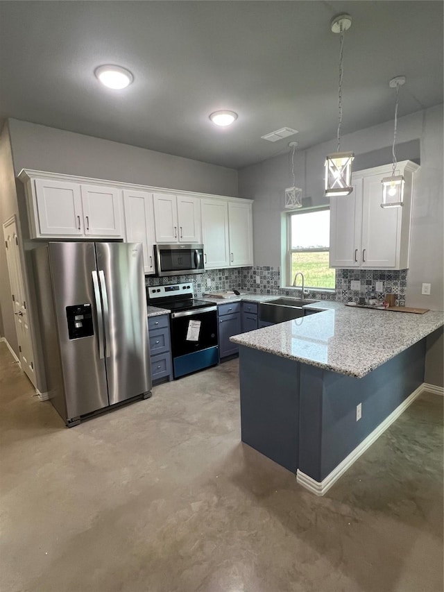 kitchen with stainless steel appliances, white cabinetry, and a peninsula