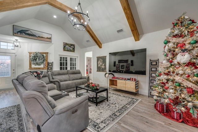 living area with high vaulted ceiling, light wood finished floors, beamed ceiling, and visible vents