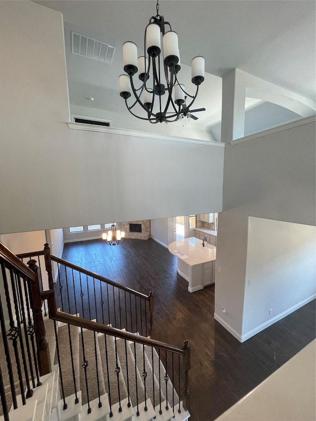 stairs with a notable chandelier and wood-type flooring