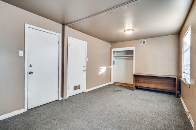 unfurnished bedroom with carpet and a closet