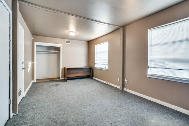 unfurnished bedroom featuring carpet flooring and a closet